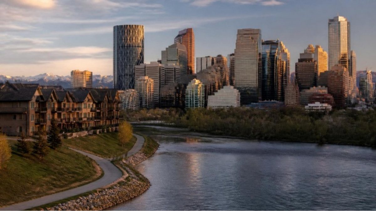 Calgary skyline beside the Bow River at golden hour
