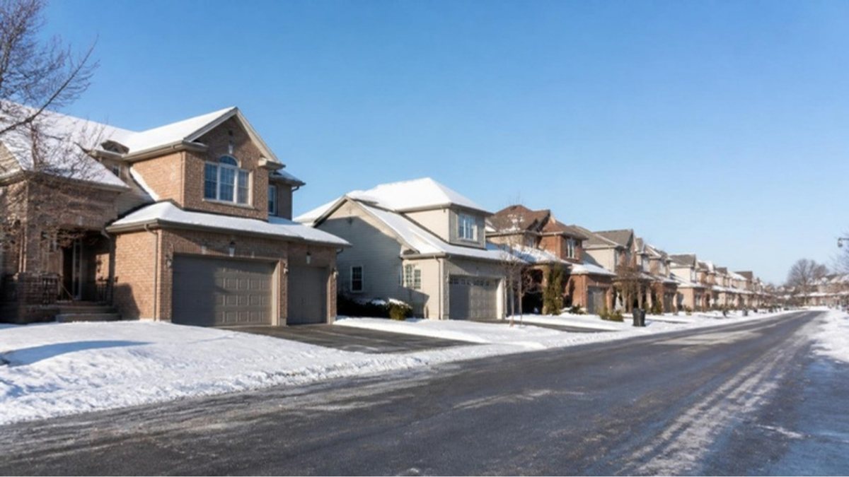 Suburban Ottawa street of family homes with light snow